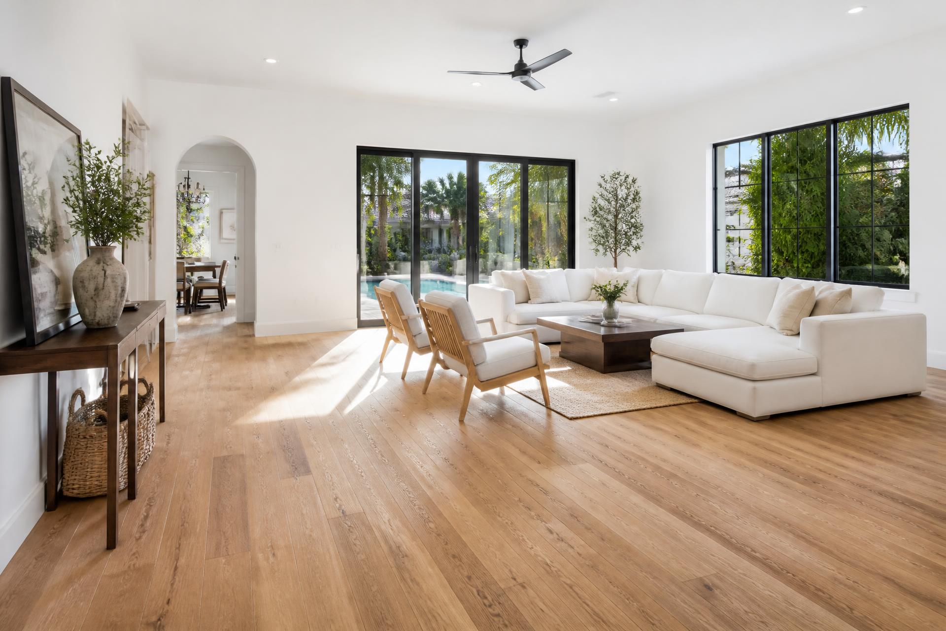 Bright South Florida living room with newly installed wide-plank wood flooring